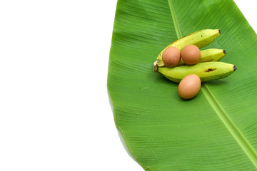 Green bananas and fresh leaves