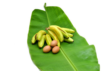 Green bananas and fresh leaves