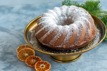 Homemade cake sprinkled with powdered sugar.
