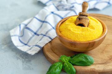 Italian polenta in a bowl and green basil.