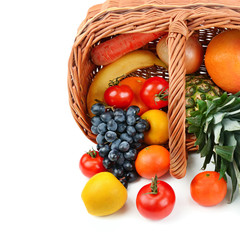 Vegetables and fruits in a basket isolated on white background. Free space for text.