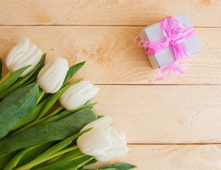white tulips present on a wooden table