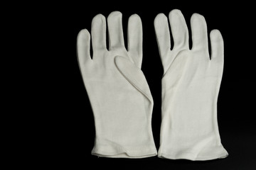 White gloves for pantomime on a black background