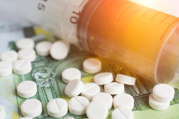 The heroin drugs and pills on money banknotes