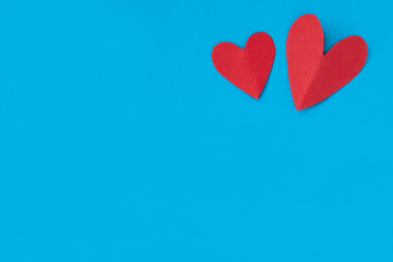 background for Valentine's day holiday, heart on blue background, couple of hearts on red and blue background