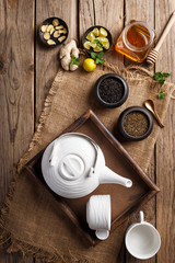 Fototapeta na wymiar Herbal Tea Ingredients - Tea Leaves, Honey, Ginger, Lemon and Mint Leaves