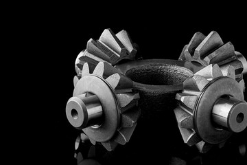 Gears, bearings and differential stars lie on the table close-up