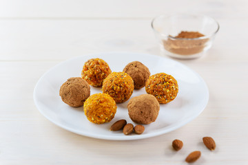 Candy of dried fruits and nuts on a white plate