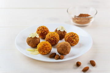Candy of dried fruits and nuts on a white plate
