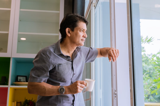 Man looking out of window - Stock Image - F009/8001 - Science