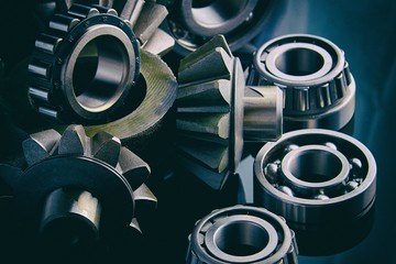 Gears, bearings and differential stars lie on the table close-up