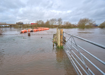 Flooded river and farm gate image