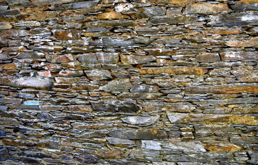 Close-up detail view of an old traditional stone wall built from schist in Piodão, made of shale rocks stack, one of Portugal's schist villages in the Aldeias do Xisto.