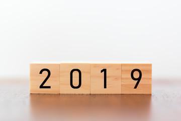 New year 2019 on wooden cubes on table with copy space for text