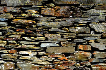 Close-up detail view of an old traditional stone wall built from schist in Piodão, made of shale rocks stack, one of Portugal's schist villages in the Aldeias do Xisto.