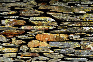 Close-up detail view of an old traditional stone wall built from schist in Piodão, made of shale rocks stack, one of Portugal's schist villages in the Aldeias do Xisto.
