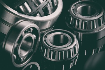 Close-up of a set of ball and roller bearings on a dark background
