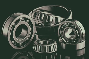Close-up of a set of ball and roller bearings on a dark background