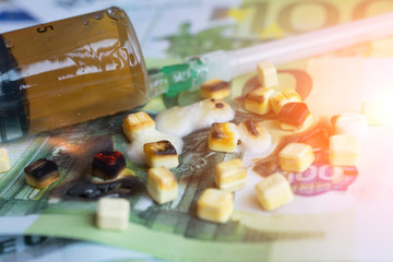 Pills and one hundred euro banknote close up