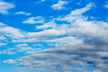 Naklejka na ściany i meble Snow-white light cumulus clouds against a blue sky