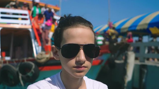 boy teenager suffers from motion sickness while on a boat trip. Fear of traveling or illness of the virus during a cruise holiday.