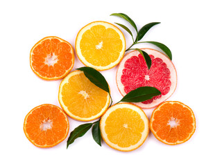 Citrus fruits isolated on white background. Isolated citrus fruits. Pieces of mandarin, pink grapefruit and orange isolated on white background, with clipping path. Top view.