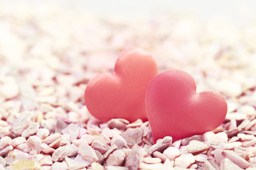 Obraz premium Two hearts on pink stones. Concept of love for Valentine's Day