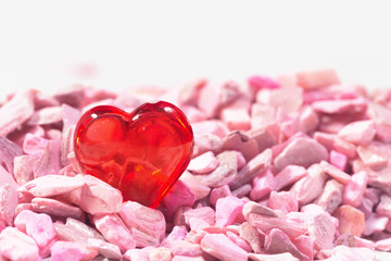 Obraz premium Glass red heart on a pink background. Concept about love