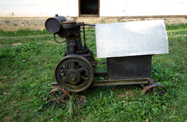 An old motor saw on wheels