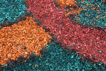 Abstract textured pattern of small colored wooden sawdust