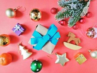 Flat lay Christmas and New Year items. Fir tree branch, shiny ornaments, wrapped gift box and...