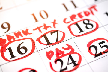 Red circle marked with pen on a calendar sheet 17 date tax sign