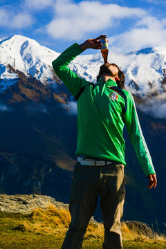 beer-hiker on top of mountain