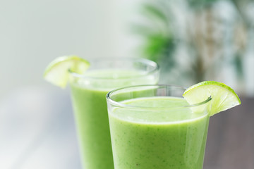 Green fresh smoothie with avocado and banana in glass, healthy lifestyle, vegan nutrition,