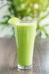 Green fresh smoothie with avocado and banana in glass, healthy lifestyle, vegan nutrition,