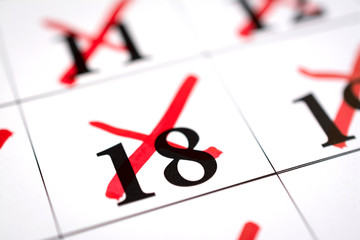 Red marked with pen on a calendar sheet 18 date
