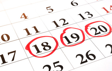 Red circle marked with pen on a calendar sheet 18, 19, 20 date