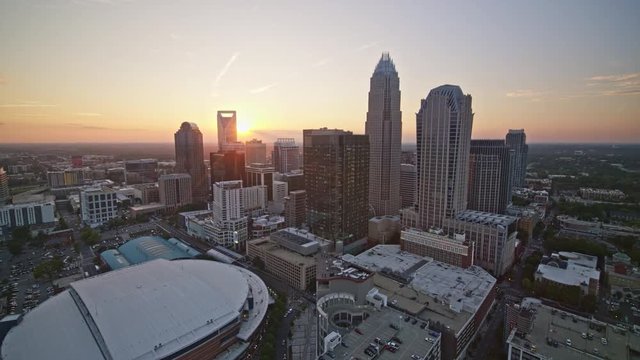 North Carolina Charlotte Aerial v35 Panning around downtown cityscape away from stadium at sunset 10/17