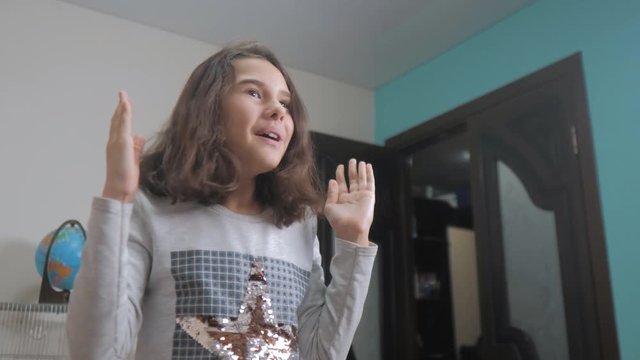 hide and seek. little girl covered her eyes face with her hands peek a boo waiting for a surprise lifestyle . slow motion video. teen girl playing bo-peep. childhood concept game hy - spy