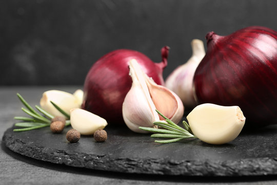 Composition with garlic and onion on slate plate