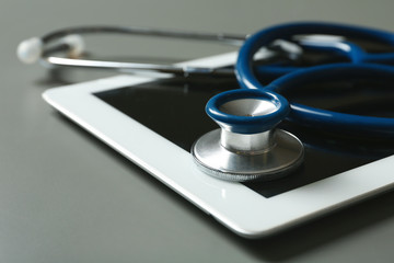 Stethoscope and tablet on table, closeup. Medical students stuff
