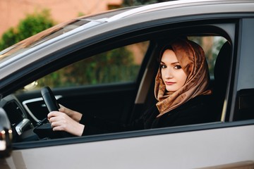 Fototapeta na wymiar Muslim woman in car as driver