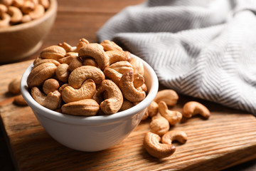 Tasty cashew nuts in bowl on table
