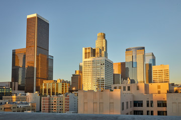 Skyline with sun setting over skyscrapers in downtown Los Angeles, California USA