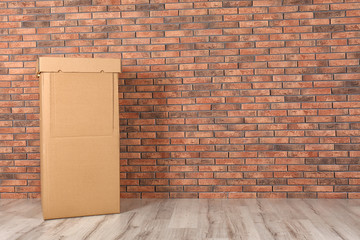 Wardrobe box against brick wall indoors. Space for text
