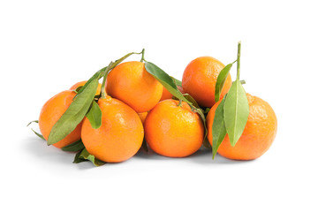 Tasty ripe tangerines with leaves on white background