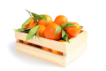 Wooden crate with tasty ripe tangerines on white background