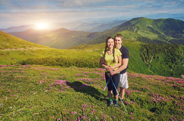 couple of hikers with backpacks enjoying panoramic view