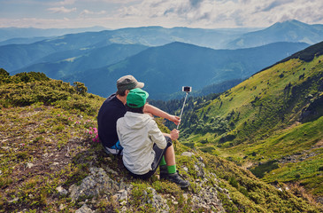 Fototapeta na wymiar Young couple hiking taking selfie with smart phone.