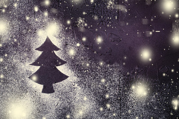 Christmas tree silhouette in snow on black background. Holiday concept